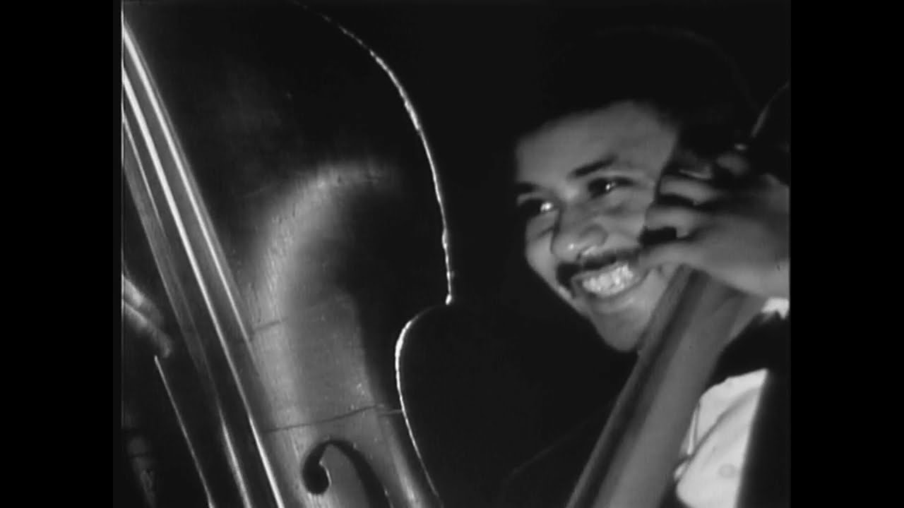 Paul Chambers playing bass and smiling